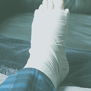 Person resting his broken foot on a pillow